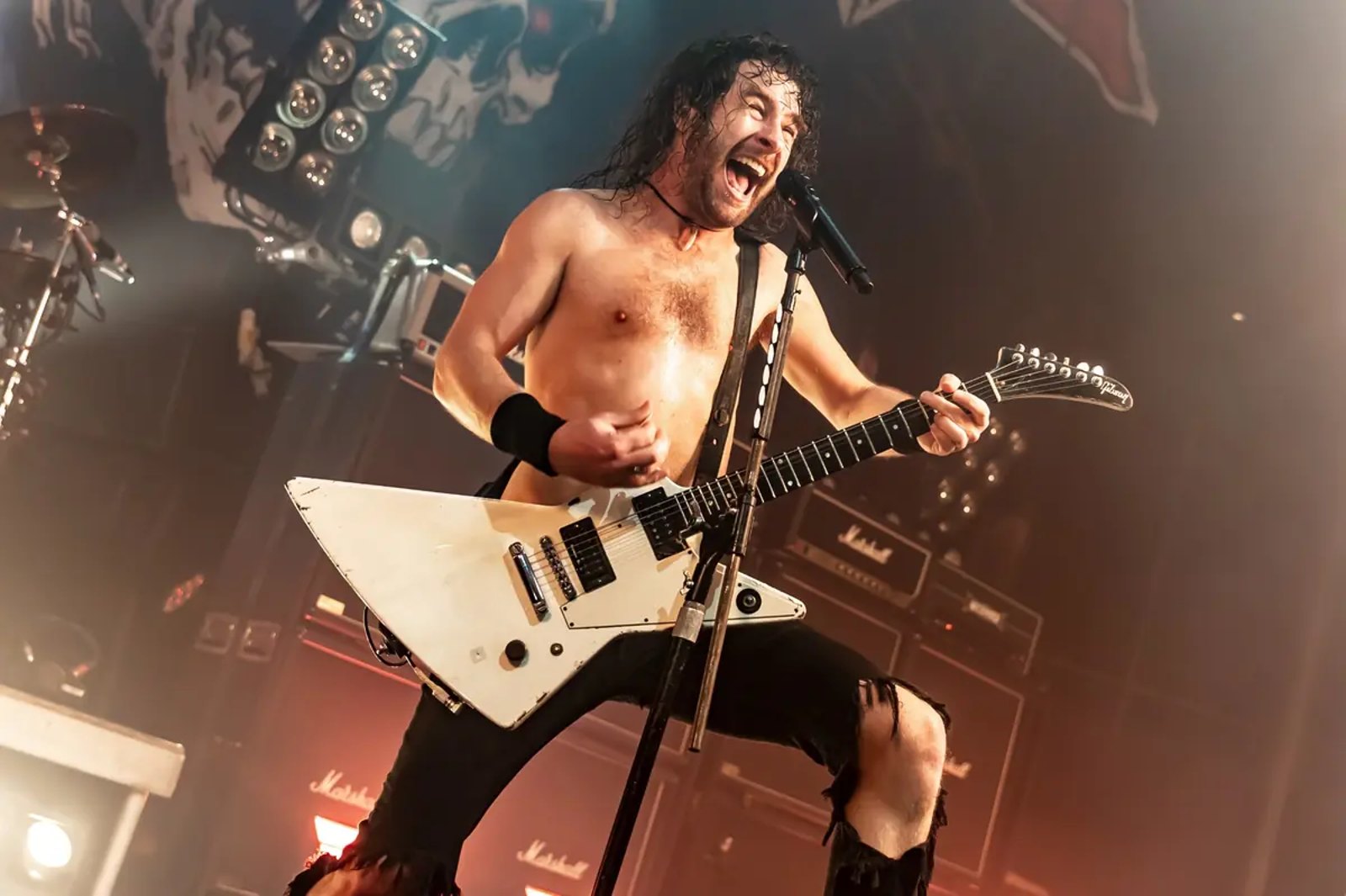 Joel O’Keeffe of Airbourne shouting into the microphone at the Roundhouse in London in February 2026