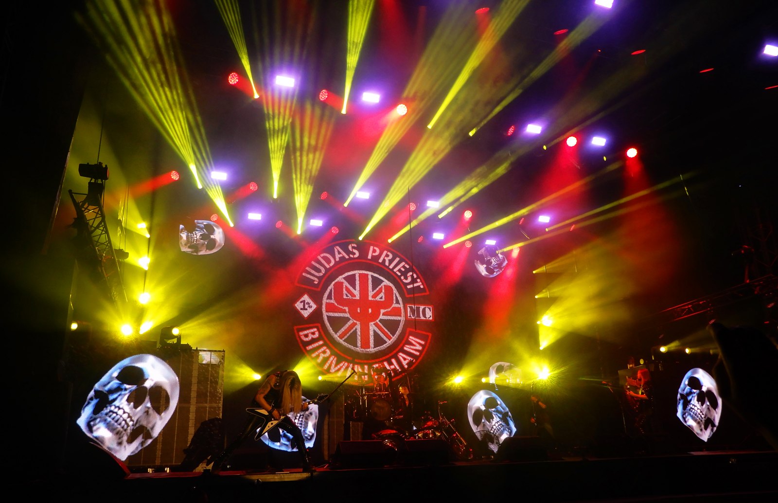 Judas Priest on stage at the Motocultor festival in August 2026, the band lit under video screens and the Birmingham crest