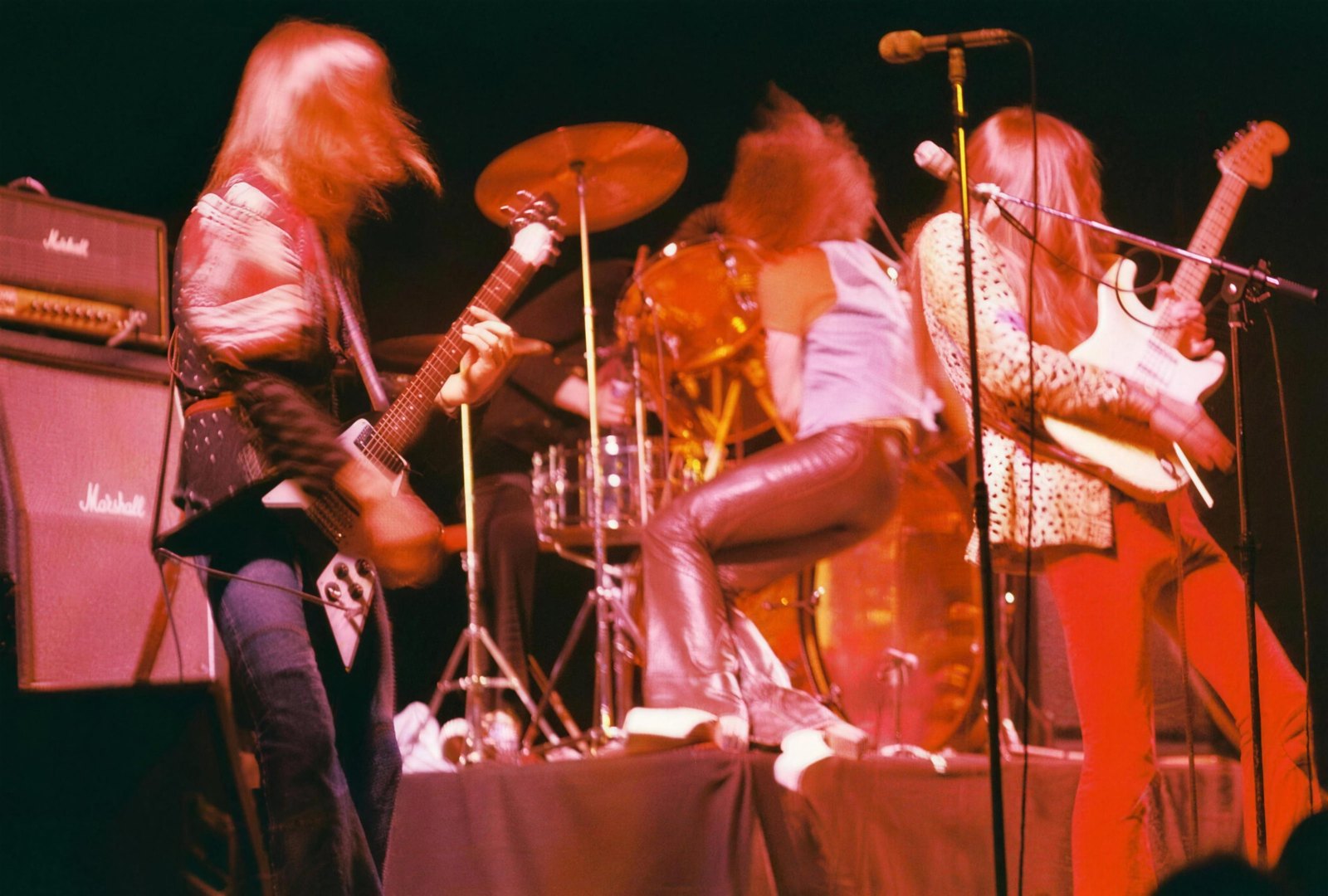 Scorpions performing live on stage supporting Kiss on their first German tour, Phillipshalle, Dusseldorf, 19 May 1976, two guitarists and the singer mid-performance