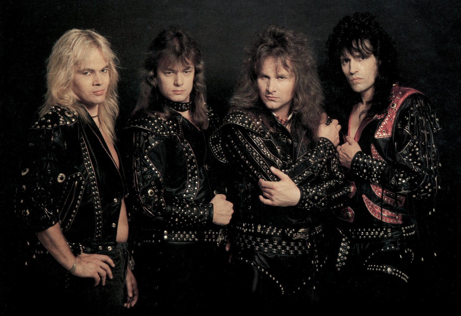 The four members of Running Wild, Rolf Kasparek among them, posed together in matching studded black leather stage jackets for a studio band portrait