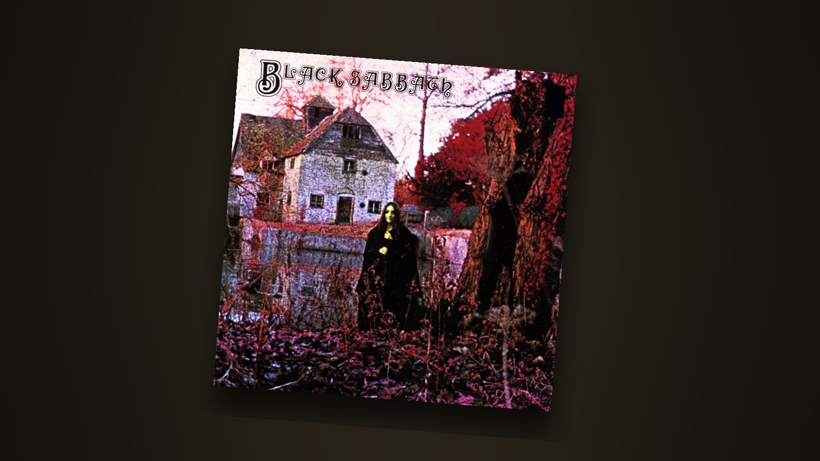 The Black Sabbath debut album sleeve, a cloaked figure standing before an old mill house among red autumn trees