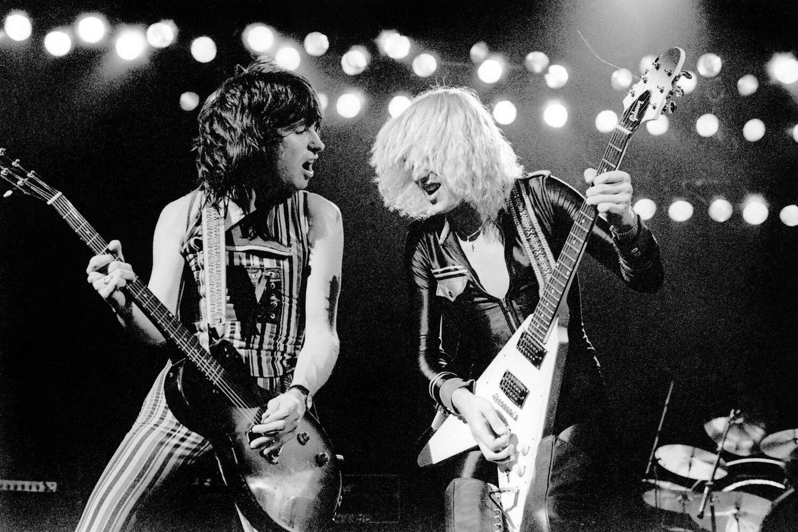 UFO performing live at Hammersmith Odeon, London, 28 June 1978, two guitarists trading a riff under a bank of stage lights