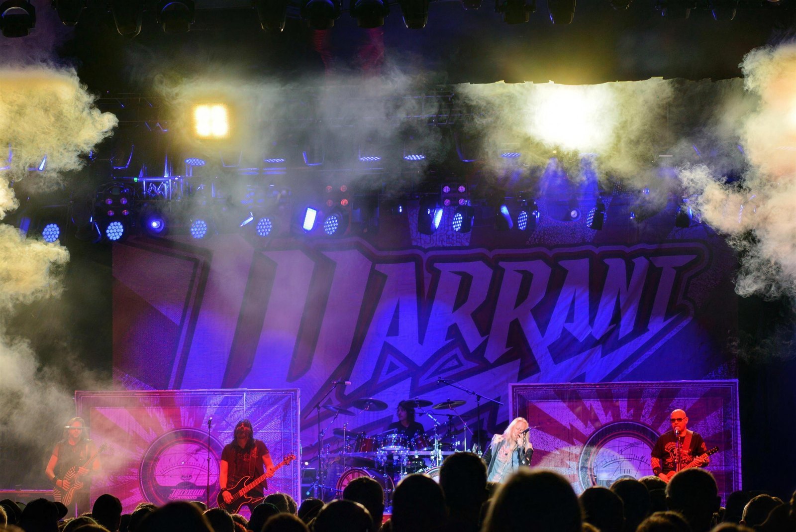 Warrant live on stage under the band's backdrop banner, MGM Northfield Park, Northfield, Ohio, 15 November 2024