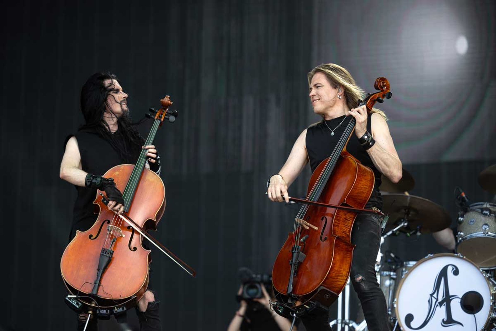 Two cellists of Apocalyptica playing facing each other at Hellfest in June 2025