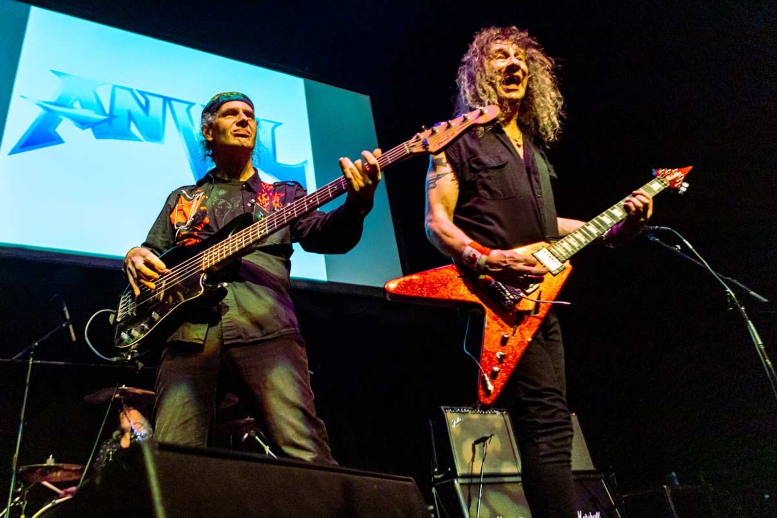 Anvil on stage in Singapore in February 2023, Steve Kudlow with a red Flying V beside bassist Chris Robertson