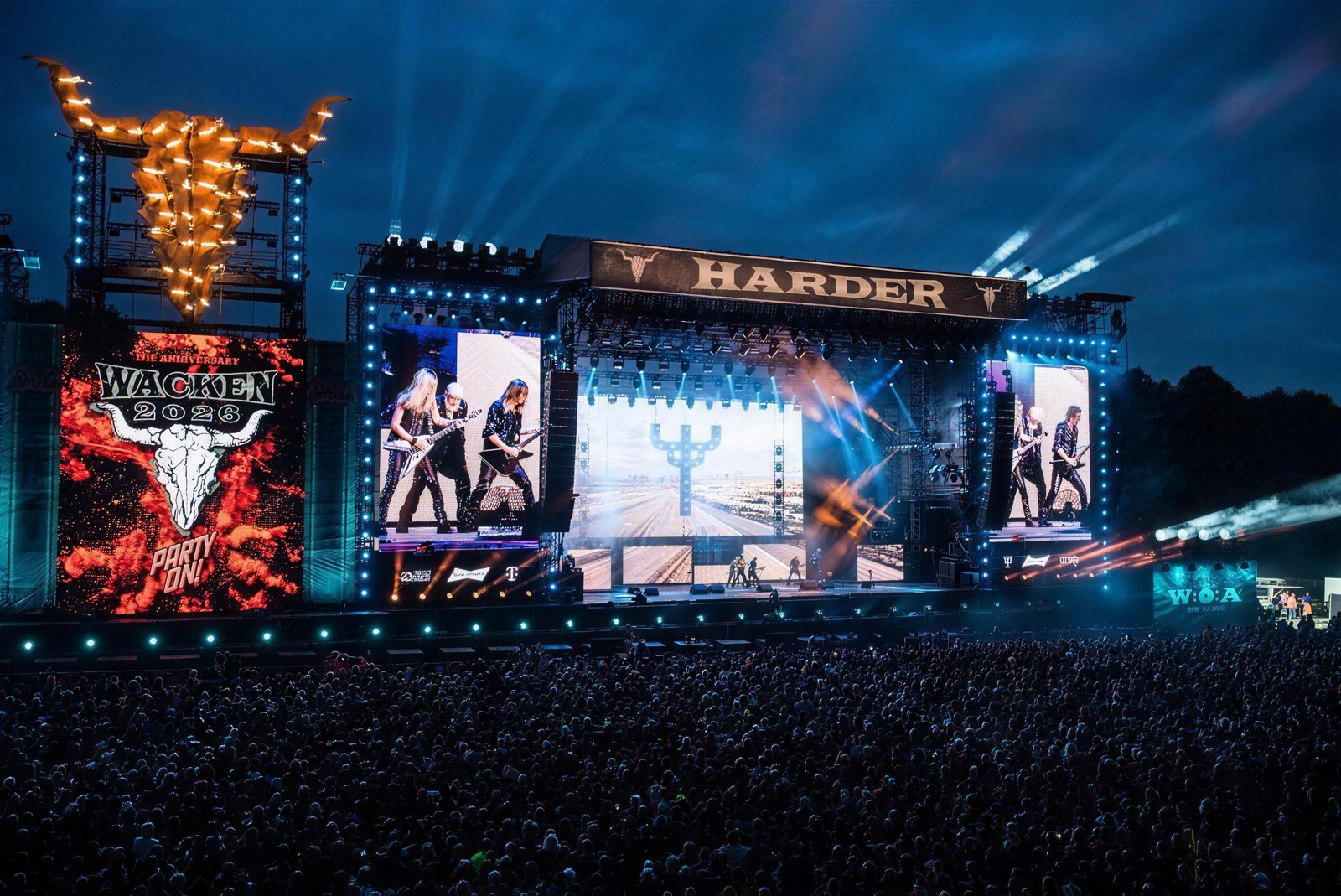 A packed crowd fills the field as Judas Priest plays the main stage at Wacken Open Air 2026.