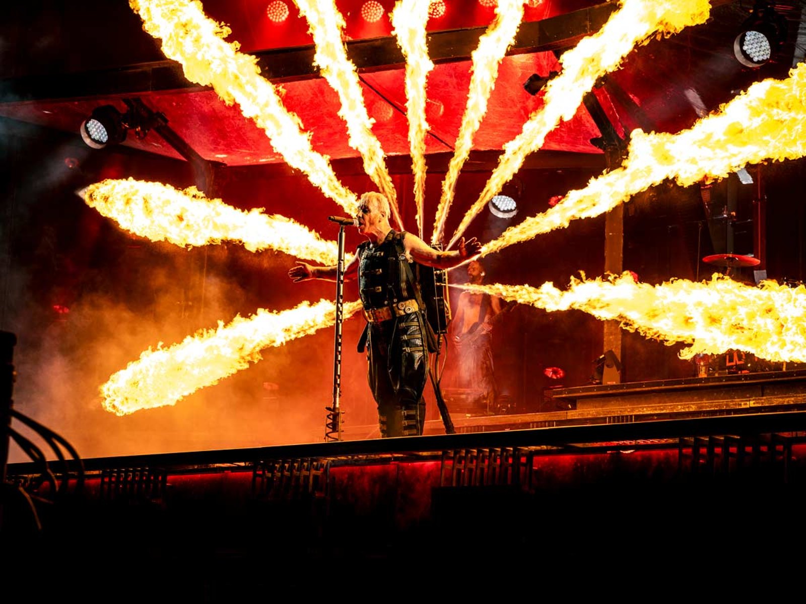 Till Lindemann of Rammstein on stage in Frankfurt in July 2024, jets of flame spreading from his back like wings