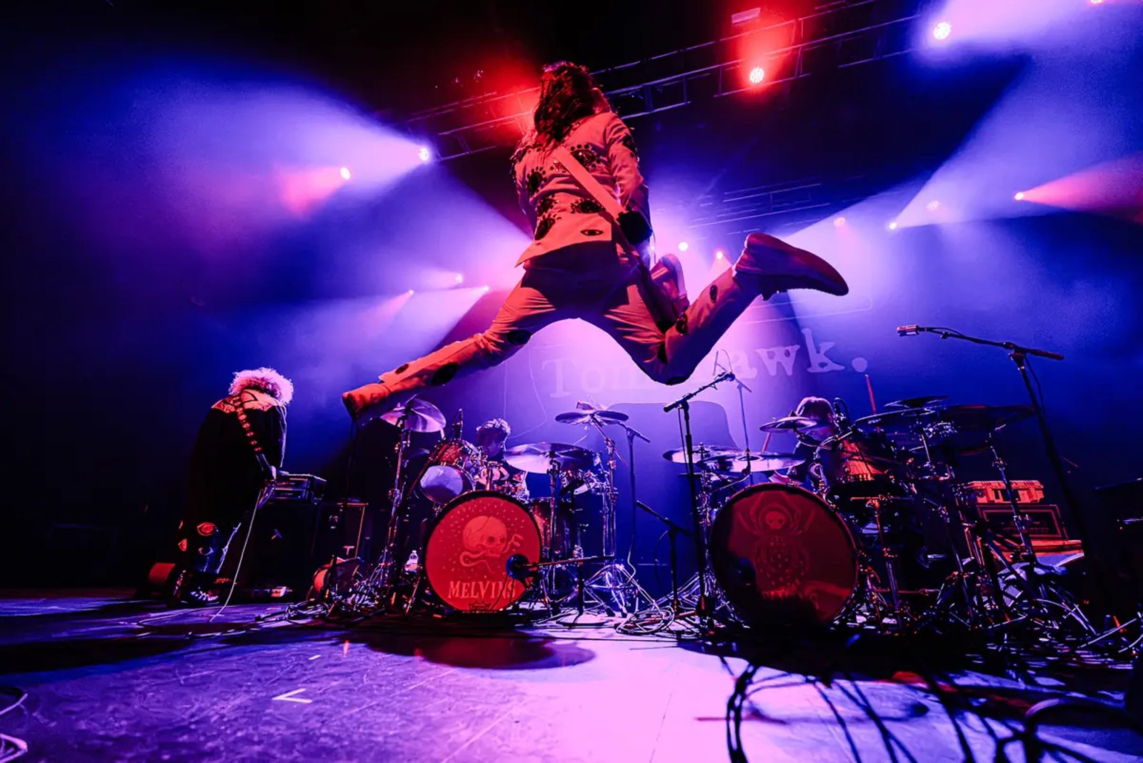 King Buzzo of the Melvins airborne above the drum kit in Boston in July 2026
