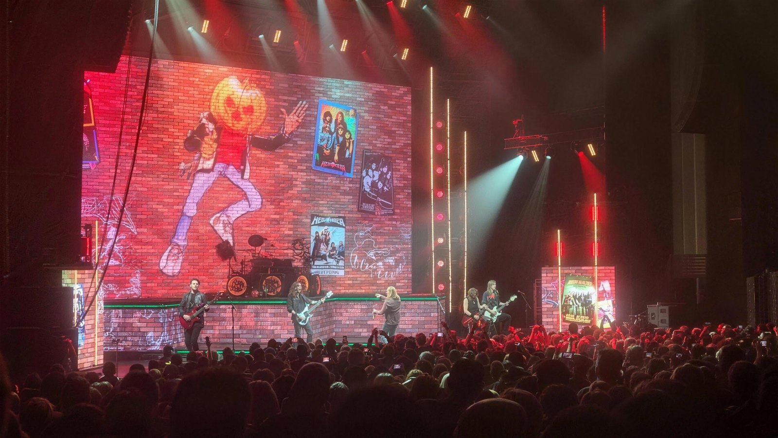 Helloween performing live at the Eventim Apollo in London, 20 October 2025, with the band on stage in front of their pumpkin-mascot video backdrop.