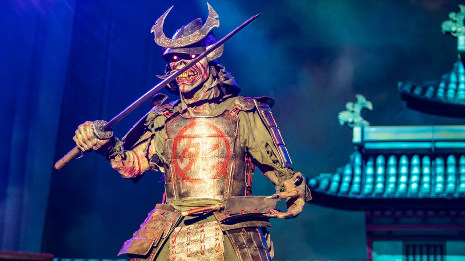 Iron Maiden's giant animatronic Samurai Eddie on stage during the Senjutsu-era tour in Portugal, sword raised in front of a pagoda backdrop
