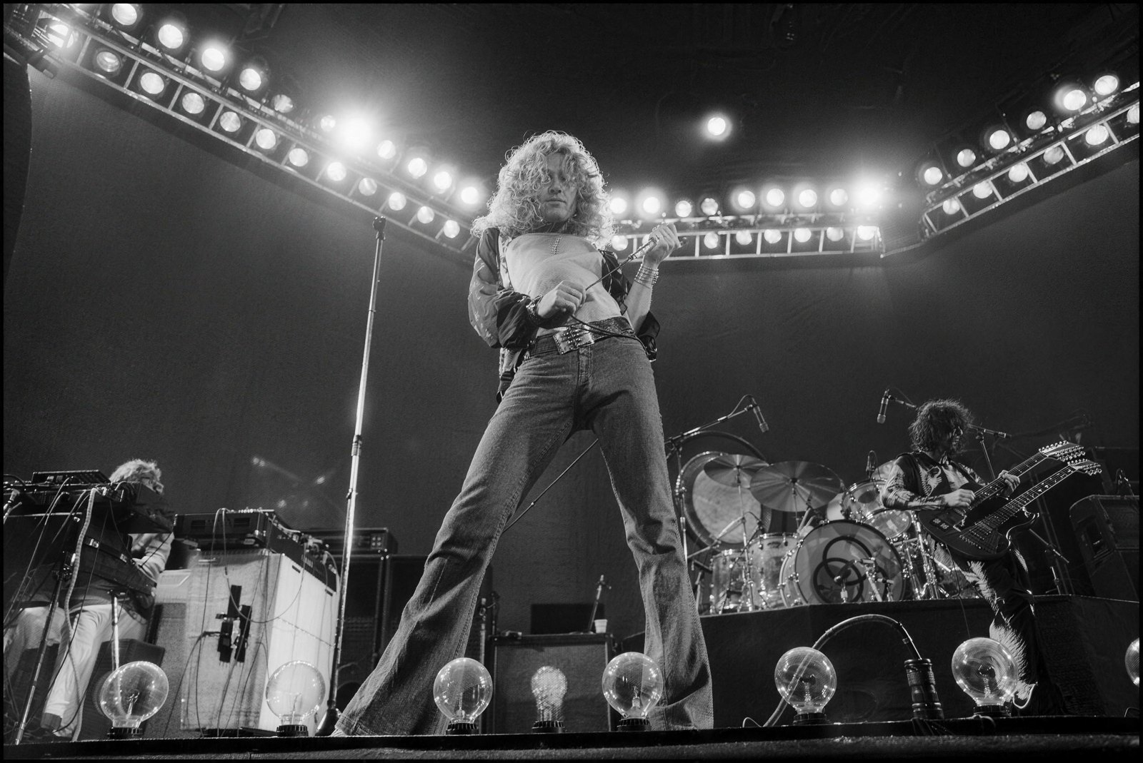 Led Zeppelin performing live at Earls Court, London, 1975, Robert Plant at the mic with John Paul Jones and Jimmy Page behind him