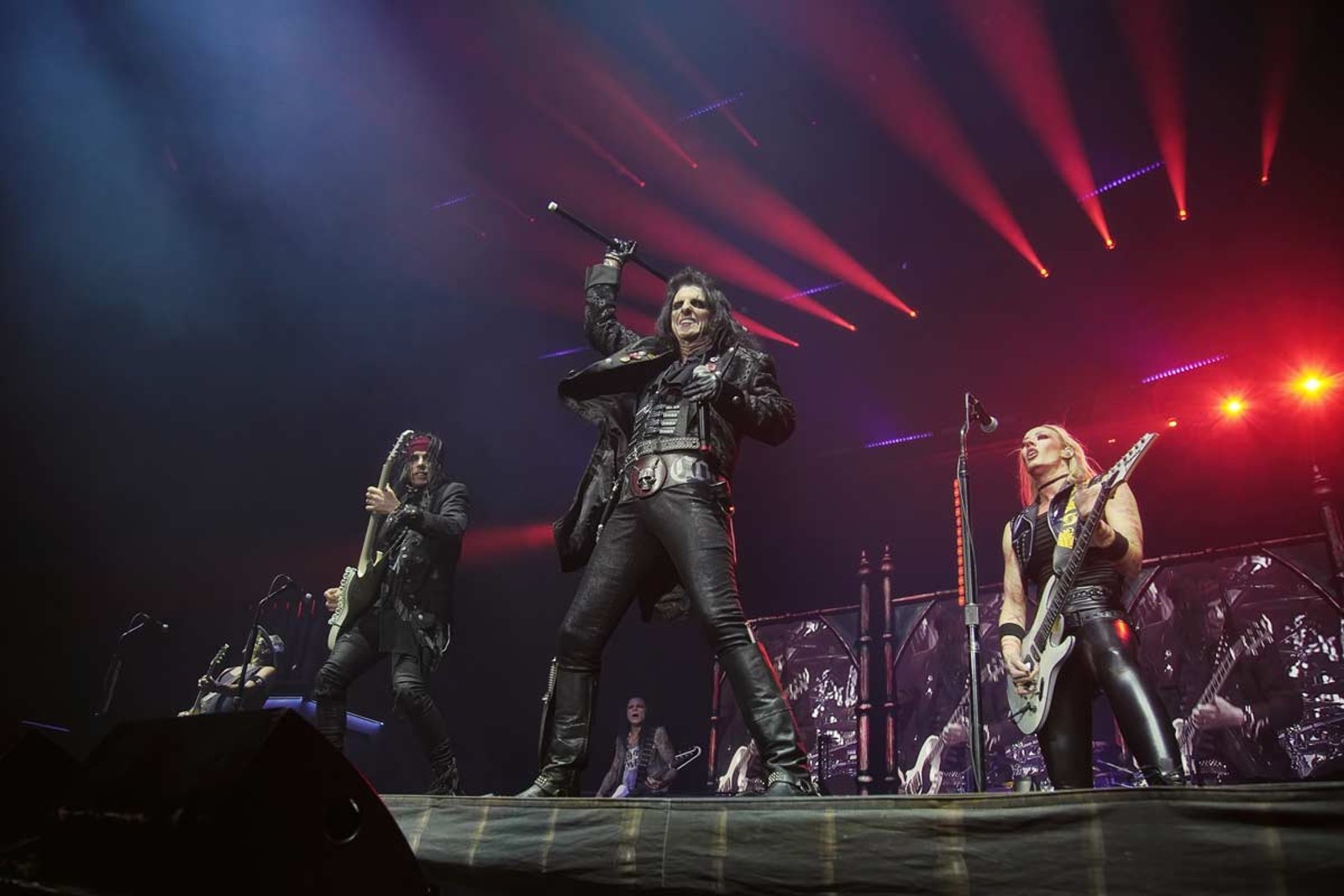 Alice Cooper on stage at the OVO Hydro in Glasgow in October 2024, cane raised above his head