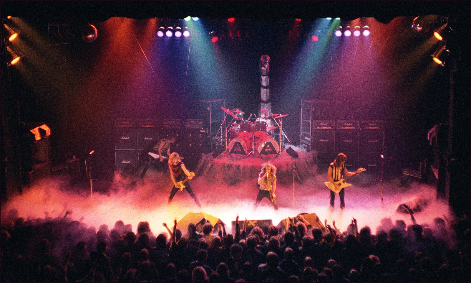 Scorpions on stage at the Manchester Apollo in February 1980, the whole stage in fog with walls of Marshall cabinets behind the band