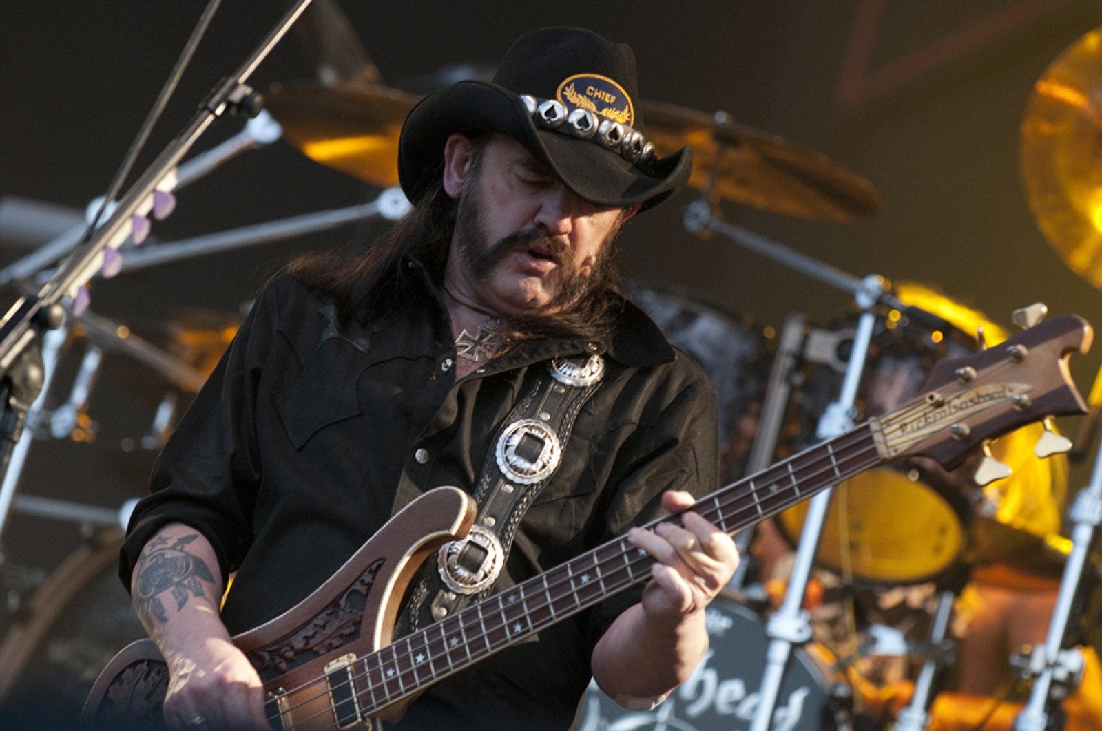 Lemmy Kilmister playing bass live at Wacken Open Air, Germany, 2013, fretting hand gripping a chord shape on the neck