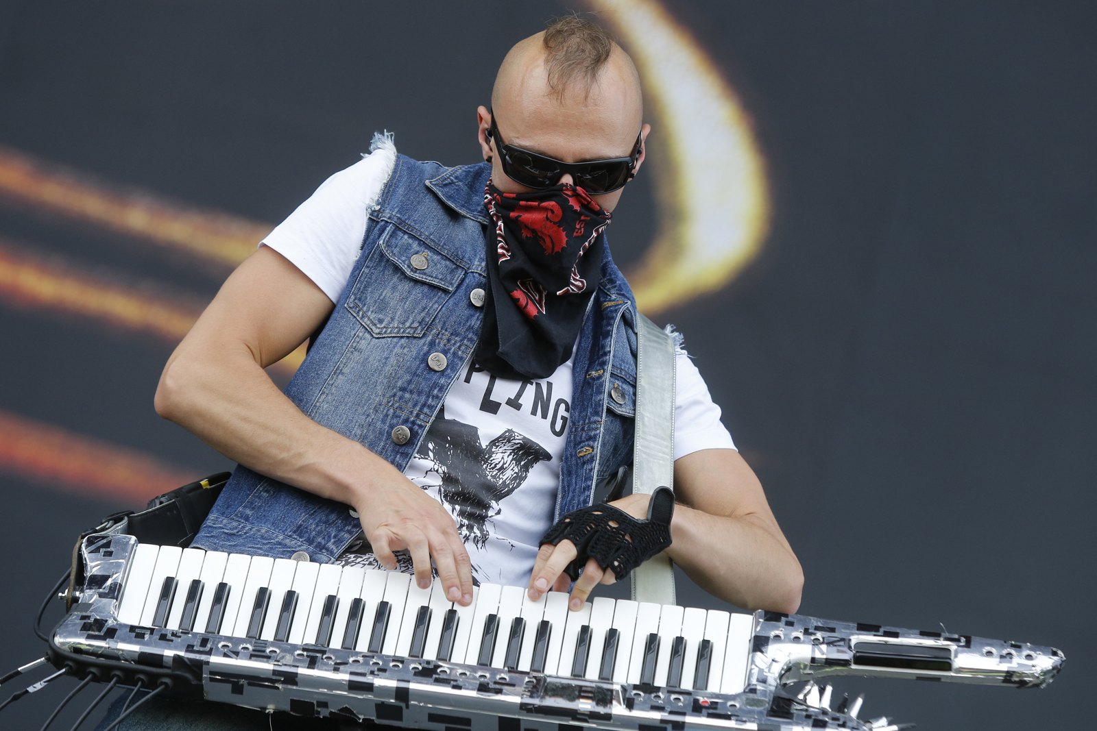Vadim Pruzhanov of DragonForce playing a keytar on the Nova Rock stage in 2013, both hands on the keys