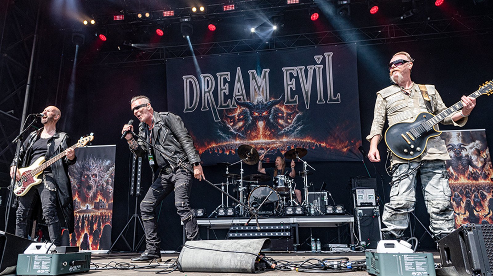 Dream Evil performing at Sweden Rock Festival 2024 in front of their backdrop banner