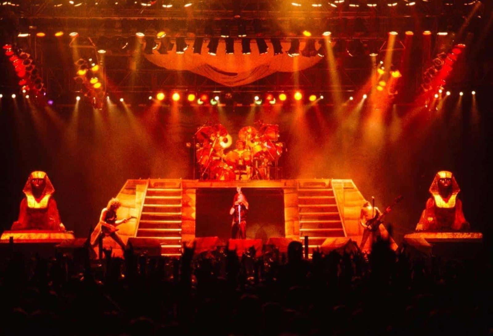 Dio performing live on stage in front of the band's giant Egyptian sphinx and pyramid set, mid 1980s