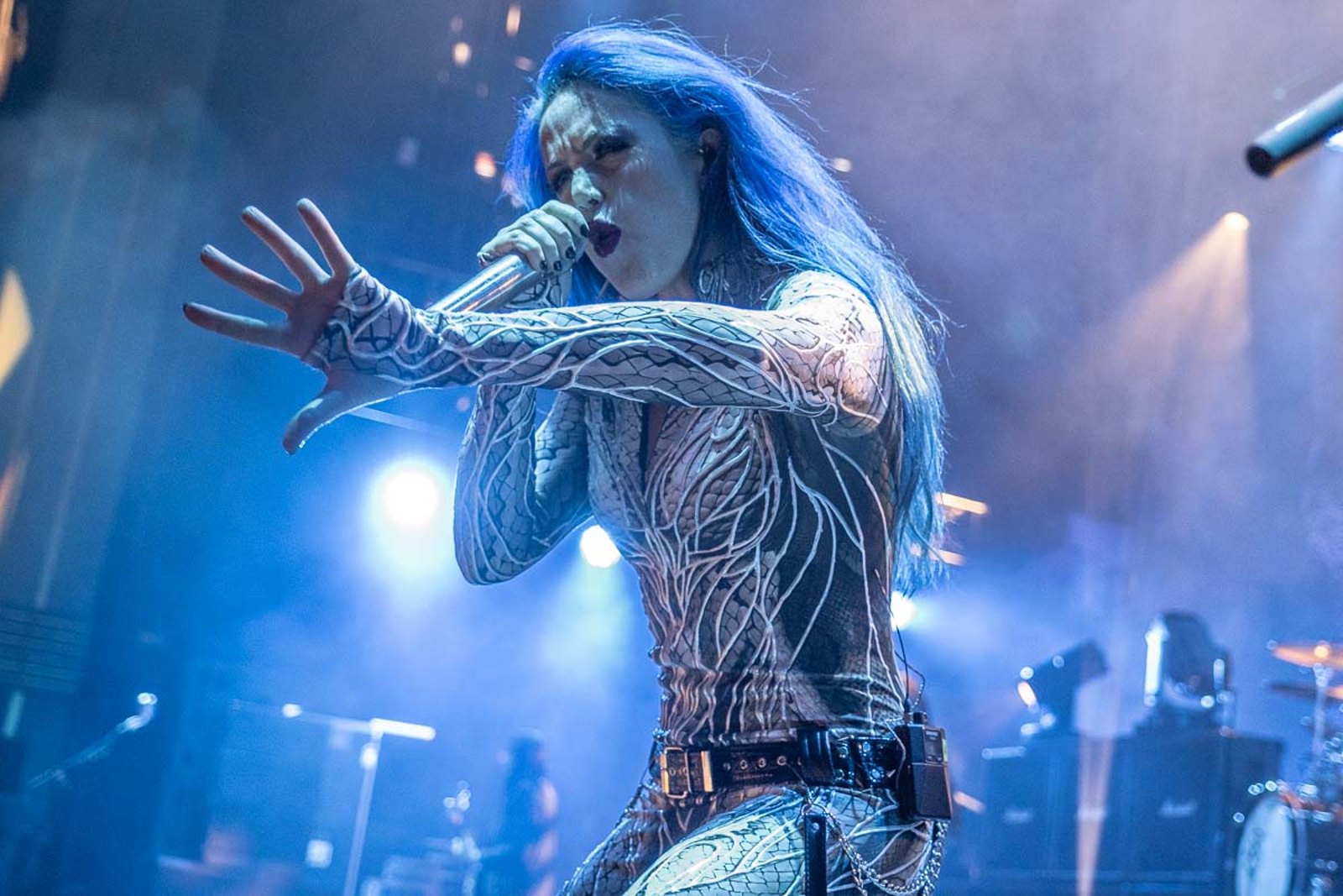 Alissa White-Gluz of Arch Enemy singing into the microphone at the Eventim Apollo in London in October 2024