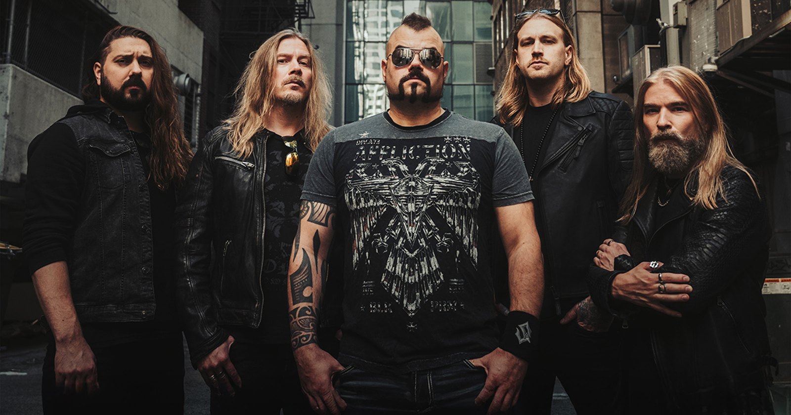 Sabaton, the five members standing in a city alley, 2025