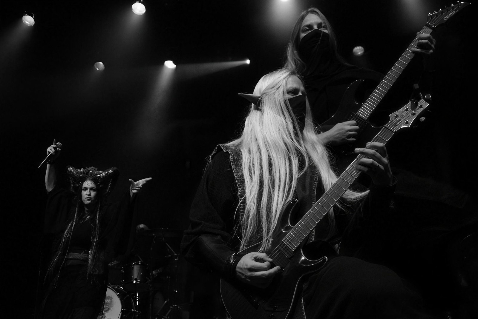 Twilight Force live at The Phoenix in Toronto, March 2024: a pointy-eared, masked guitarist plays in the foreground while a second guitarist rises behind him and the horned vocalist points from the left.