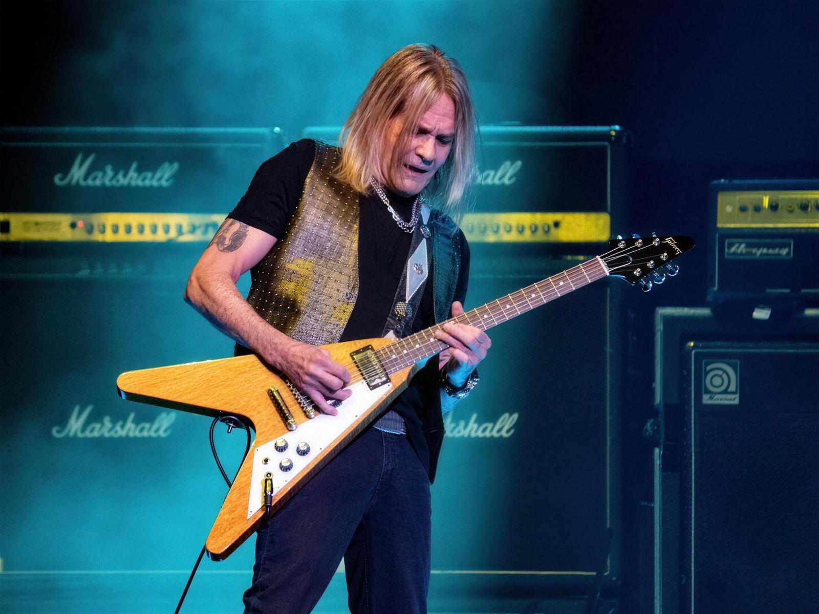 Warren DeMartini of Ratt playing his Flying V guitar live at Mohegan Sun Arena, Uncasville, Connecticut, during the Invasion Celebration reunion show, 5 April 2025