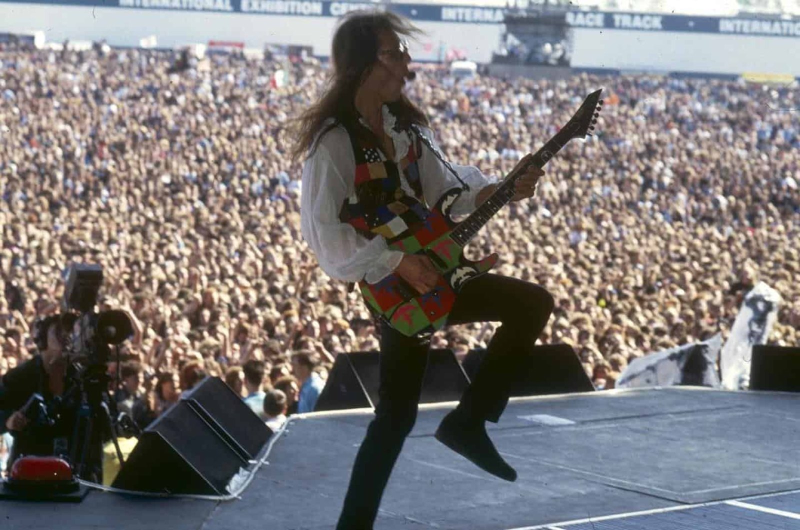 A Queensryche guitarist leaps mid-air before a packed crowd at Monsters of Rock, Donington, UK, 17 August 1991, during the Empire tour